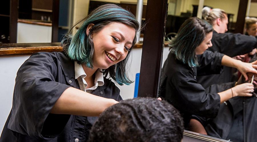 a young woman trimming hair